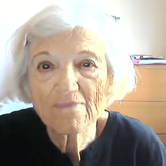 Holocaust survivor Ms. Toby Levy speaking to an audience