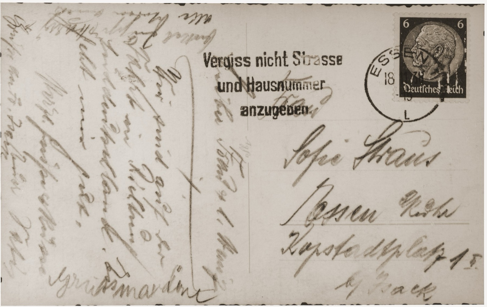 The reverse of a postcard, filled edge to edge with cursive handwriting in ink, the address block ruled off to one side and a stamp and postmark in the corner.